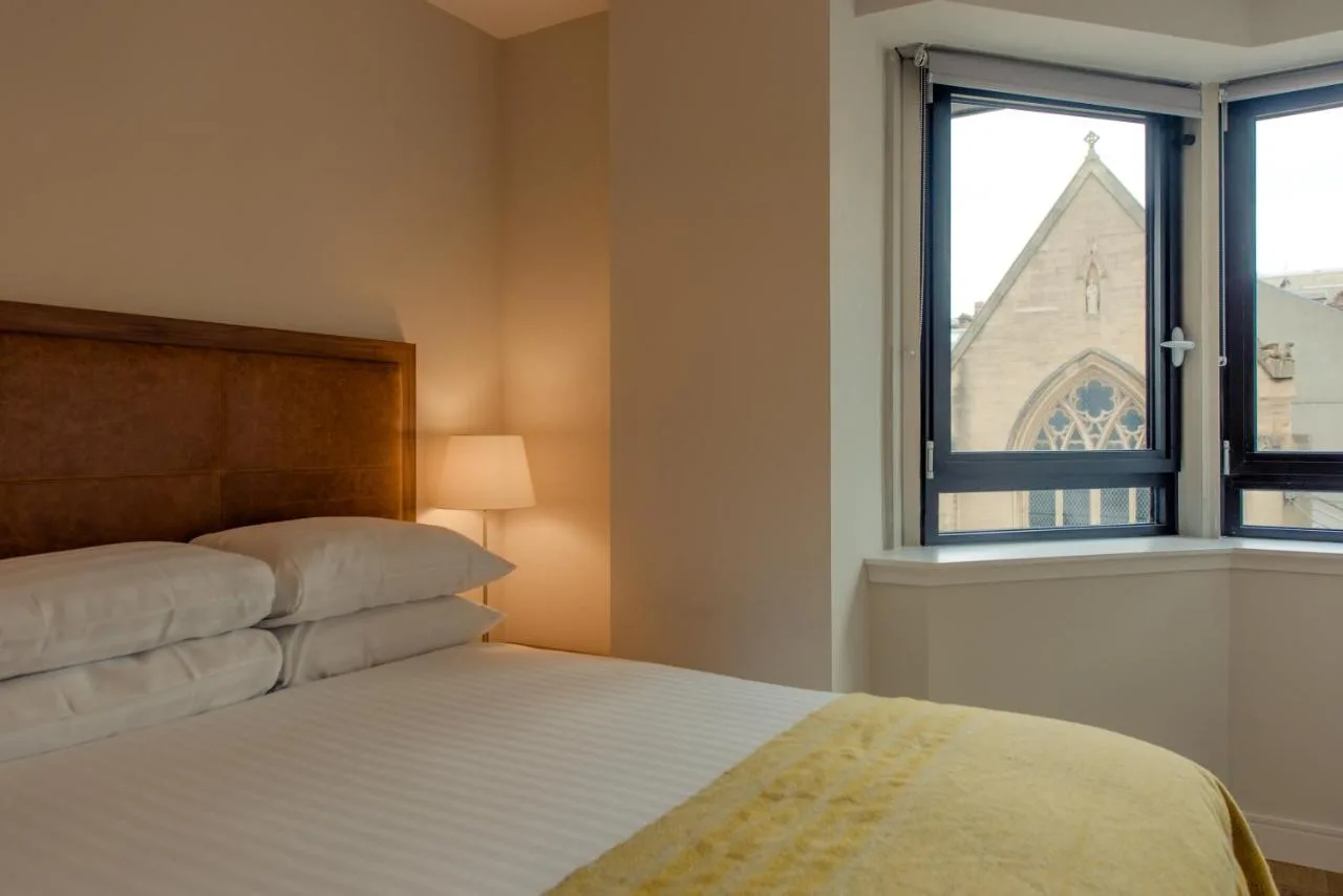 Bedroom with a bed and window at the Bath Street aparthotel in Glasgow