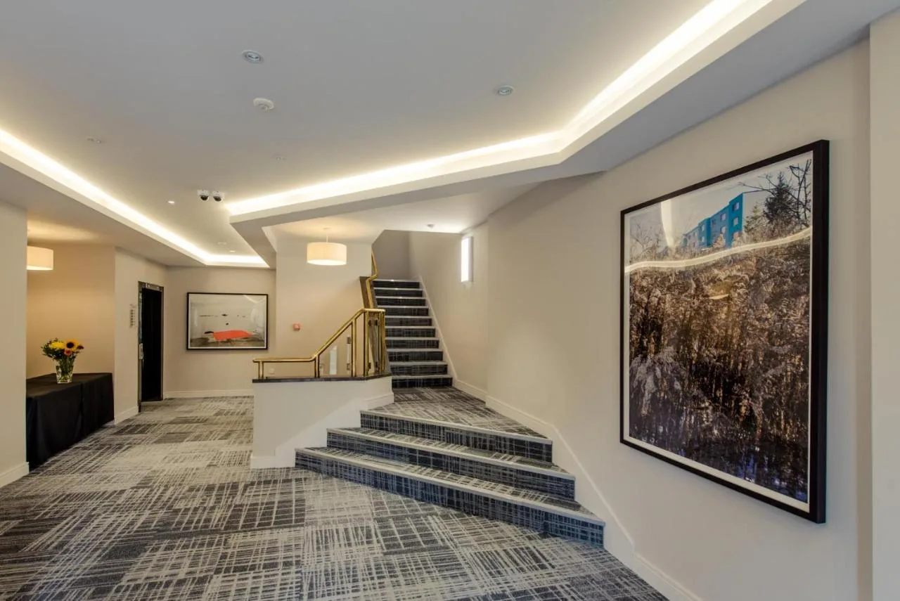 Hallway with stairs and a painting inside the Glasgow City Centre property